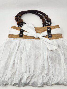 New white cloth handbag with tan straw band and brown bead handle